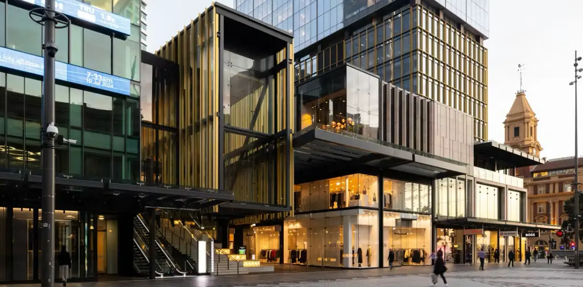 The Commercial Bay precinct on Auckland's waterfront, lit up at dusk.